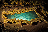 Rimstone around a gour pool of water at Lake Castrovalva inside Lechuguilla Cave.; Carlsbad Caverns National Park, New Mexico.