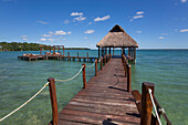 Tiki hut gazebo on dock with turquoise water at Rancho Encantado Eco-Resort & Spa in Bacalar; Quintana Roo, Mexico