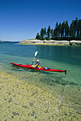 Woman kayaking, Penobscot Bay, Maine.; Penobscot Bay, Maine.