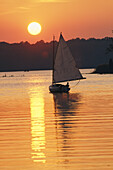 Sailboat and sunset, South River, Maryland.; SOUTH RIVER, MARYLAND.