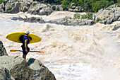 Kayaker scouts big whitewater rapids on the Potomac River; Great Falls, Potomac River, Virginia/Maryland.