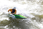 A kayaker surfs a standing wave.; Great Falls, Potomac River, Virginia.