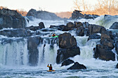 Kayakers running Great Falls of the Potomac River.; Great Falls, Maryland.