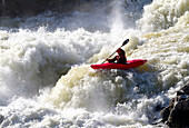 A kayaker big white water runs the lower section of Great Falls.; Potomac River, Maryland.