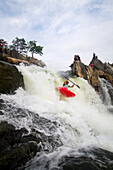A kayaker plummets off a big drop at Great Falls on the Potomac River.; Great Falls, Virginia, United States.