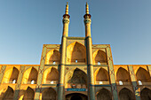 Jamesh Mosque of Yazd reflecting the golden sunlight against a blue sky; Yazd City, Yazd Province, Iran