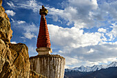 Close-up of a stupa of a Tibetan Buddhist gompa with snowy mountains in the background; Jammu and Kashmir, India