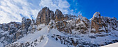 Jagged mountain peaks of the Sella Group at Passo Gardena covered in snow in the Val Gardena, Bolzano District; Trentino Alto Adige, Dolomites, Italy