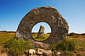 View through the holed stone of the prehistoric Men-an-Tol standing stones near Penzance; Cornwall, England, Great Britain
