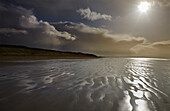 Stormy sunlight on the beach at Berrow, near Burnham-on-Sea; Somerset, England, Great Britain