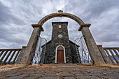 Archway and front entrance to Þingeyrakirkja on a cloudy day. One of the oldest stone churches in Iceland; North Iceland, Iceland