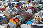 Close-up aerial view of downtown Reykjavík as seen from the top of the church, with brightly colored houses and rooftops creating a beautiful effect; Reykjavík Iceland