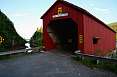 The Point Wolfe covered bridge and the Wolfe River Gorge leading into the Bay of Fundy.; Fundy National Park, New Brunswick, Canada.