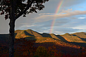 A rainbow in the sky at dawn as seen from the Hancock Overlook on the Kancamagus Highway.; New Hampshire, USA.