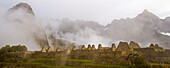 Cloud shrouded Machu Picchu; Machu Picchu, Peru