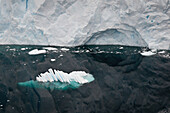 Glacier Reflected In The Water Along The Coastline; Antarctica
