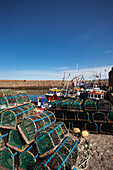 Lobster Cages Piled Along The Water's Edge; Dunbar Scottish Borders Scotland