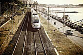 Train And Traffic On The Road Along The Waterfront; Cannes Provence France