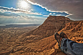A Man Sits Looking Out Over The Dead Sea At Masada; Isreal