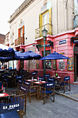 Tables Chairs And Umbrellas On An Outdoor Restaurant Patio; Buenos Aires Argentina