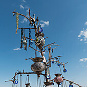 Beaded Jewelry And Lanterns Hanging On Display Against A Blue Sky; Nevsehir Turkey