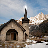 A Church With A Steeple And Mountains In The Background; Chamonix-Mont-Blanc Rhone-Alpes France