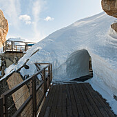 A Tunnel Through A Pile Of Snow On A Wooden Walkway; Chamonix-Mont-Blanc Rhone-Alpes France