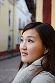 Young Korean woman with old Spanish buildings in background; Guanajuato, Guanajuato State, Mexico