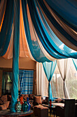 Morocco, Marrakech, Blue and white draped fabric in room