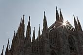 Close up of cathedral spires backlit; Milano, Lombardia, Italy