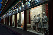 Statues Along The Illuminated Wall Of A Building At Night Along The Lianhu Ancient City Wall; Xi'an, Shaanxi, China