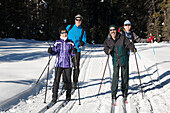 Two Sets Of Cross Country Skiier Couples On Tracked Trail; Lake Louise, Alberta, Canada