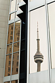 Reflection Of The Cn Tower In A Gold Glass Building Window; Toronto, Ontario, Canada