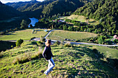 A Young Woman Admiring The View Overlooking Blue Duck Valley At Blue Duck Lodge, In Whanganui National Park; Whakahoro, New Zealand