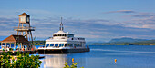 Tour Boat On Lac Memphremagog And An Observation Tower On A Pier; Magog, Quebec, Canada