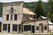 An Old Abandoned Wooden Building Falling Down; Dawson City, Yukon, Canada