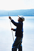 Boy Adjusting Fishing Rod, Algonquin Park, Ontario, Canada