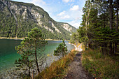 Landscape of a trail beside a clear lake in autumn, Plansee, Tirol, Austria