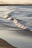 Nahaufnahme von pastellfarbenen Wellen, die am Strand von Byron Bay in New South Wales, Australien, an die Küste schlagen