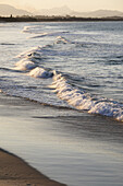 Close-up of pastel waves hitting shoreline on beach at Byron Bayin New South Wales, Australia