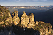 Sunlight reflecting on the Three Sisters rock formation in the Blue Mountains National Park in New South Wales, Australia