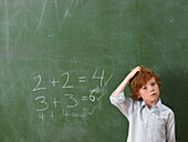 Boy Standing at Blackboard