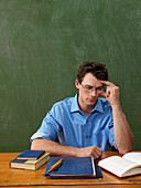 Teacher Reading at Desk
