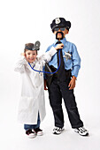 Girl Dressed as Doctor Checking Boy Dressed as Police Officer