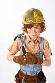Little Boy Dressed Up as Construction Worker Holding a Hammer