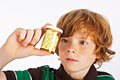 Boy Looking at Pill Bottle