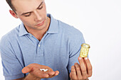 Man Looking at Pills