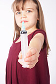 Girl Holding a Needle