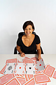 Mid-Adult Woman doing Magic Trick with Deck of Cards