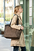 Woman Carrying Handbag Looking at Directory